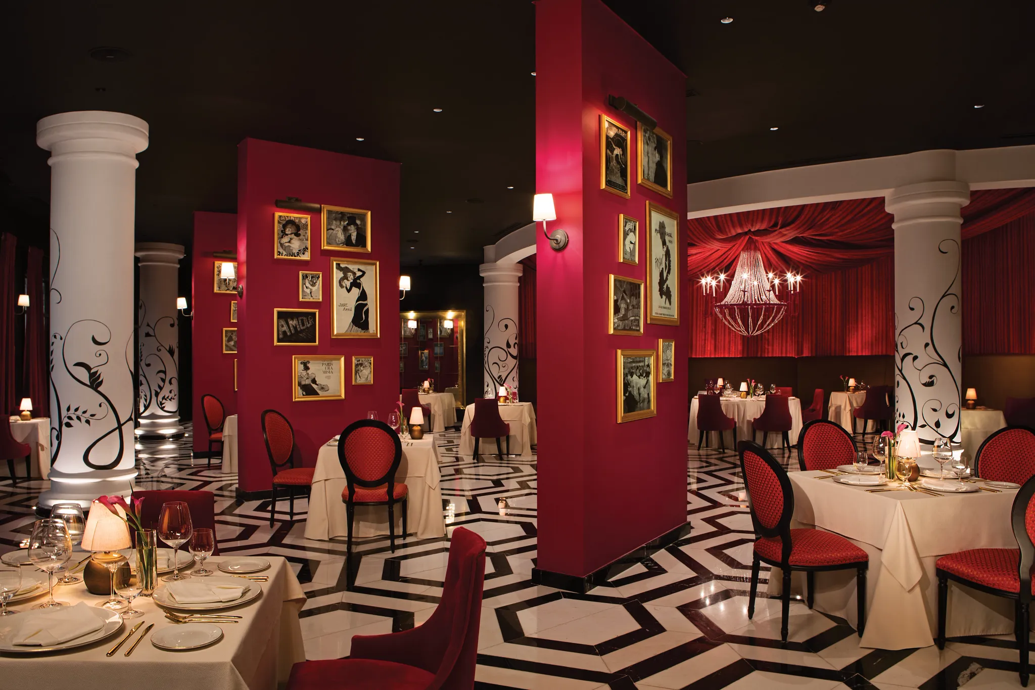 Bordeaux French Restaurant at Secrets Akumal Riviera Maya featuring elegant red décor, white tablecloth dining, and a romantic Moulin Rouge-inspired ambiance.