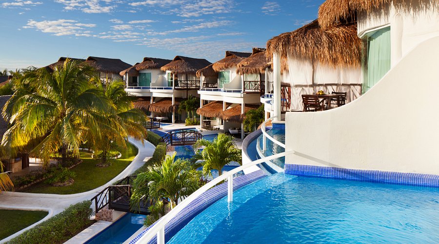 El Dorado Royale adults-only Gourmet Inclusive resort with thatched-roof casitas, beachfront pools, and lush tropical gardens on the Riviera Maya.