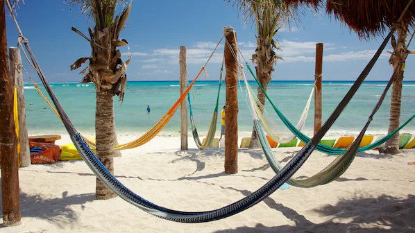 Colorful beach hammocks and turquoise Caribbean views at Half Moon Bay near Secrets Akumal Riviera Maya