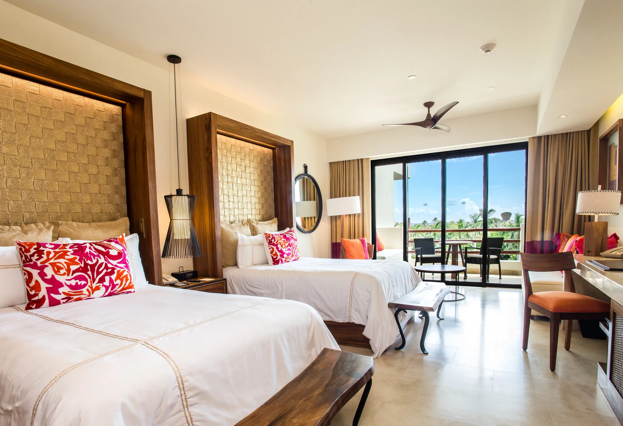 Junior Suite Partial Ocean View with two double beds and private balcony at Secrets Akumal Riviera Maya.