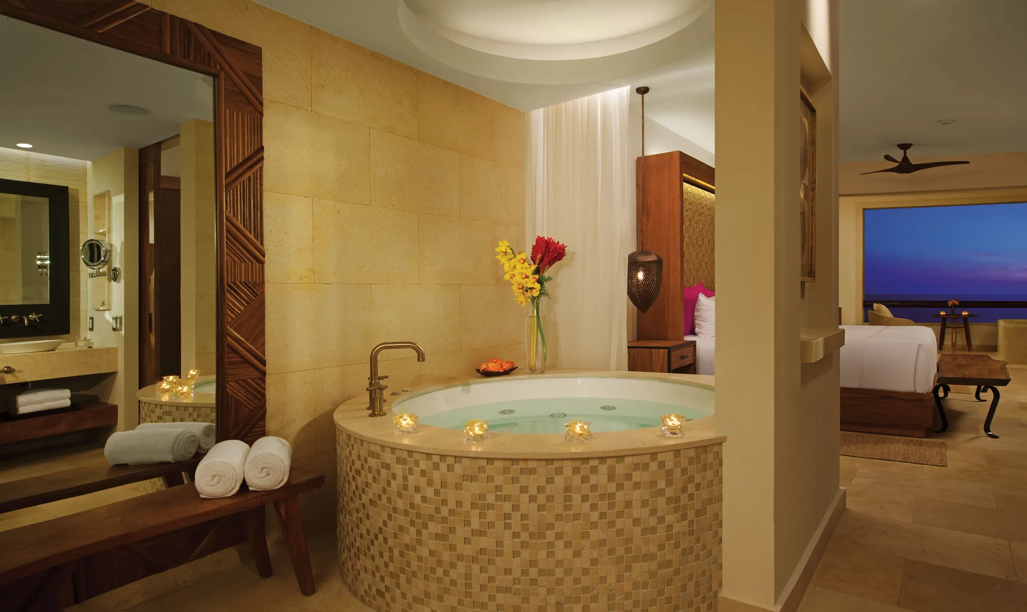 Preferred Club Junior Suite Ocean Front in-room hot tub with candles and luxury décor at Secrets Akumal Riviera Maya.