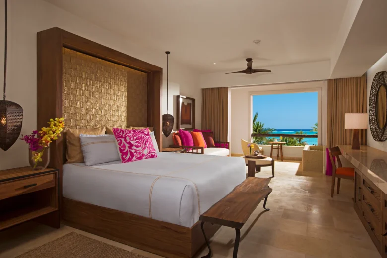 Preferred Club Junior Suite Ocean Front with king bed and oceanfront balcony view at Secrets Akumal Riviera Maya.