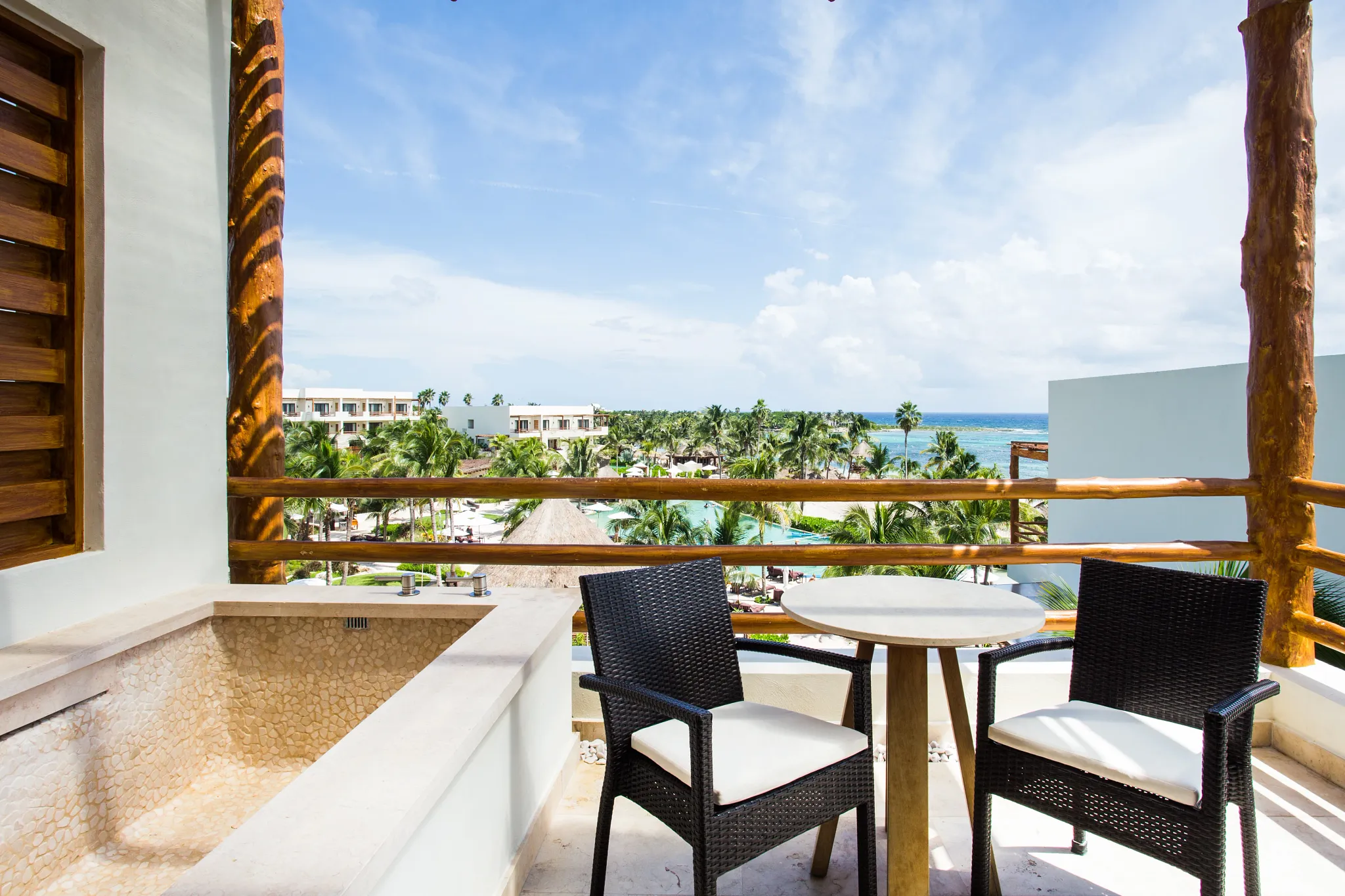 Preferred Club Junior Suite Ocean View balcony with plunge pool and outdoor seating at Secrets Akumal Riviera Maya.