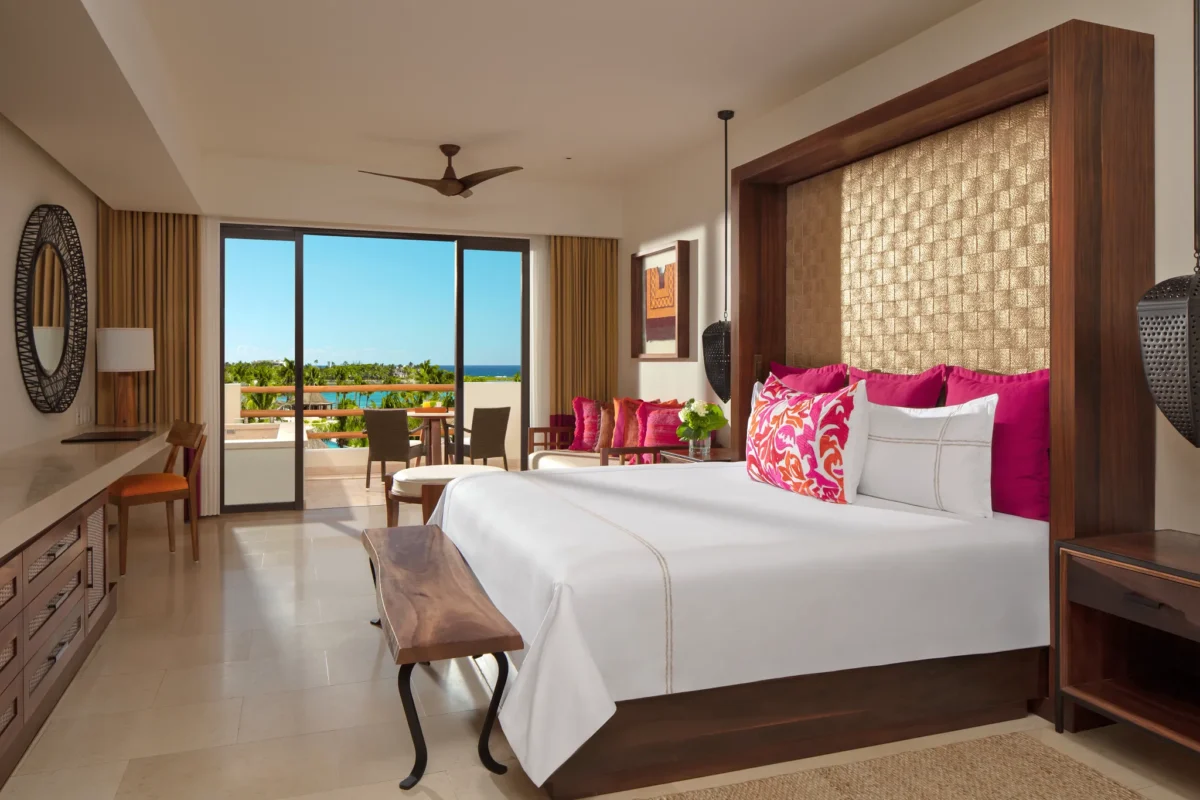 Preferred Club Junior Suite Ocean View with king bed and sitting area at Secrets Akumal Riviera Maya.
