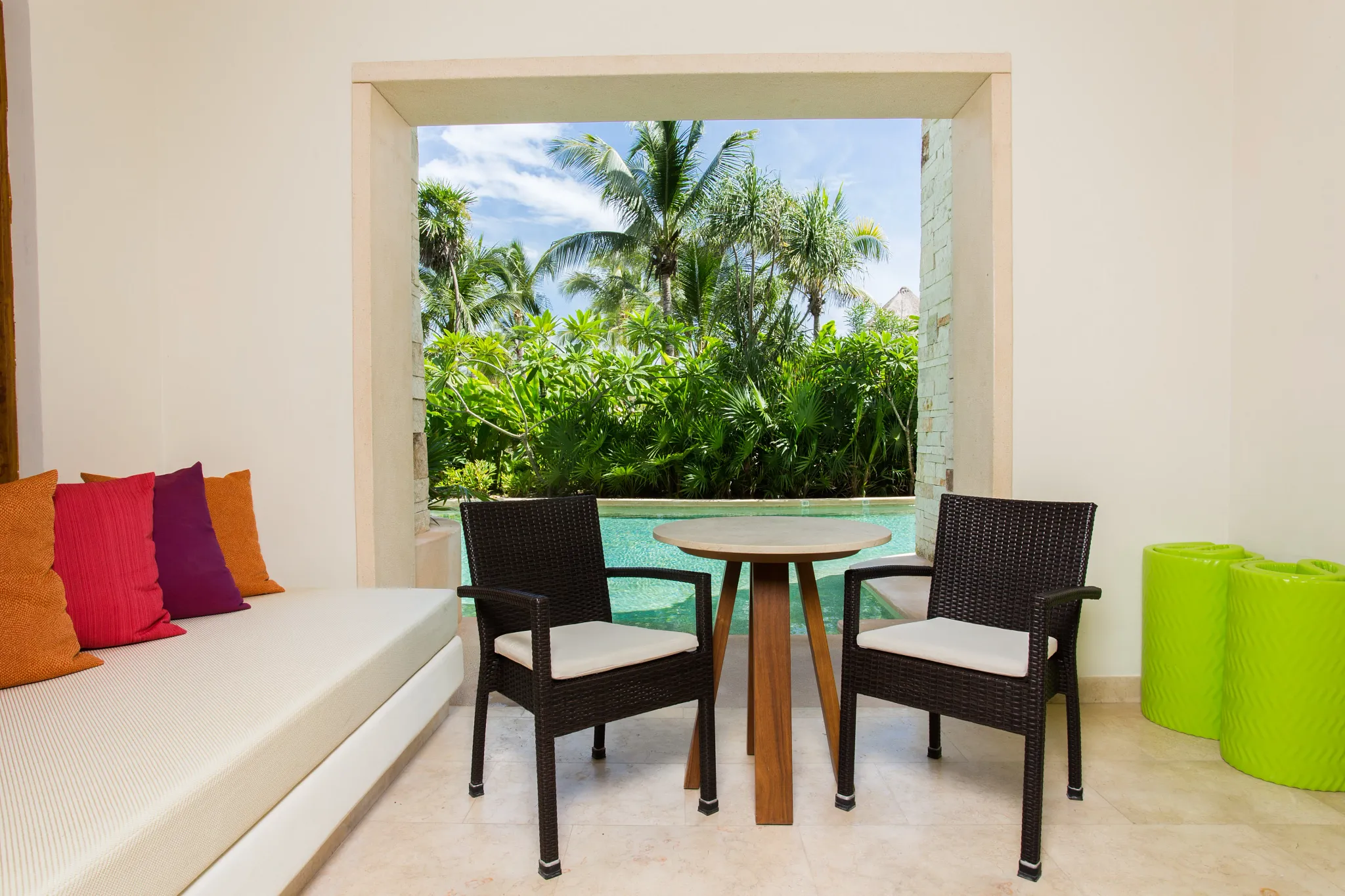 Preferred Club Junior Suite Swim Out terrace with table seating and direct pool access at Secrets Akumal Riviera Maya.