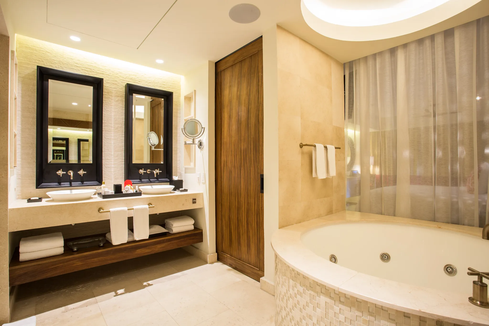 Preferred Club Junior Suite Tropical View bathroom with double sinks and in-room hot tub at Secrets Akumal Riviera Maya.