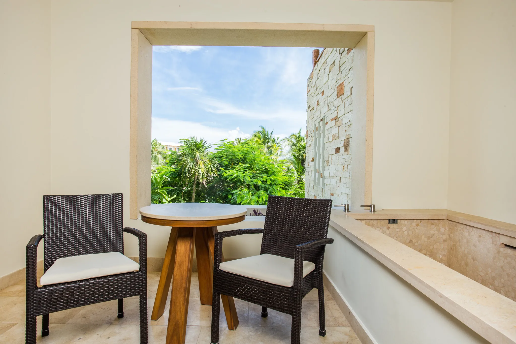 Preferred Club Junior Suite Tropical View terrace with table seating and private plunge pool at Secrets Akumal Riviera Maya.