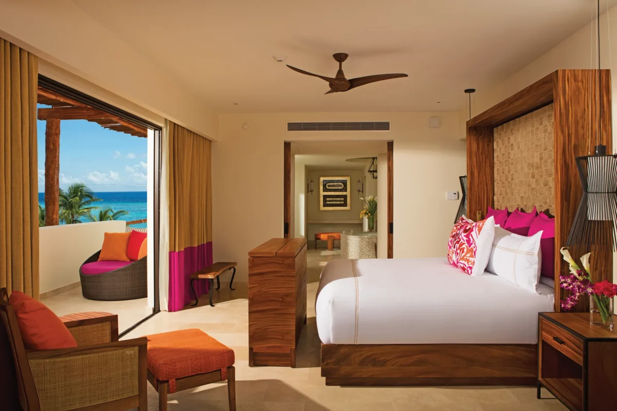 Romance Master Suite Ocean Front bedroom with king bed and oceanview balcony at Secrets Akumal Riviera Maya.