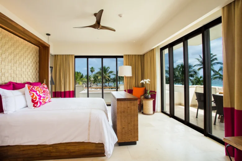 Romance Master Suite Ocean View with king bed and corner balcony doors at Secrets Akumal Riviera Maya.
