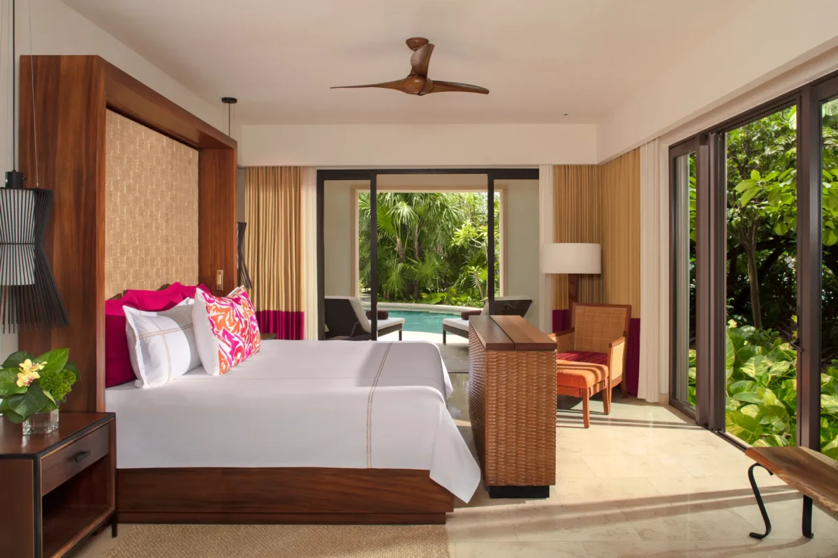 Romance Master Suite Swim Out bedroom with king bed and terrace access at Secrets Akumal Riviera Maya.