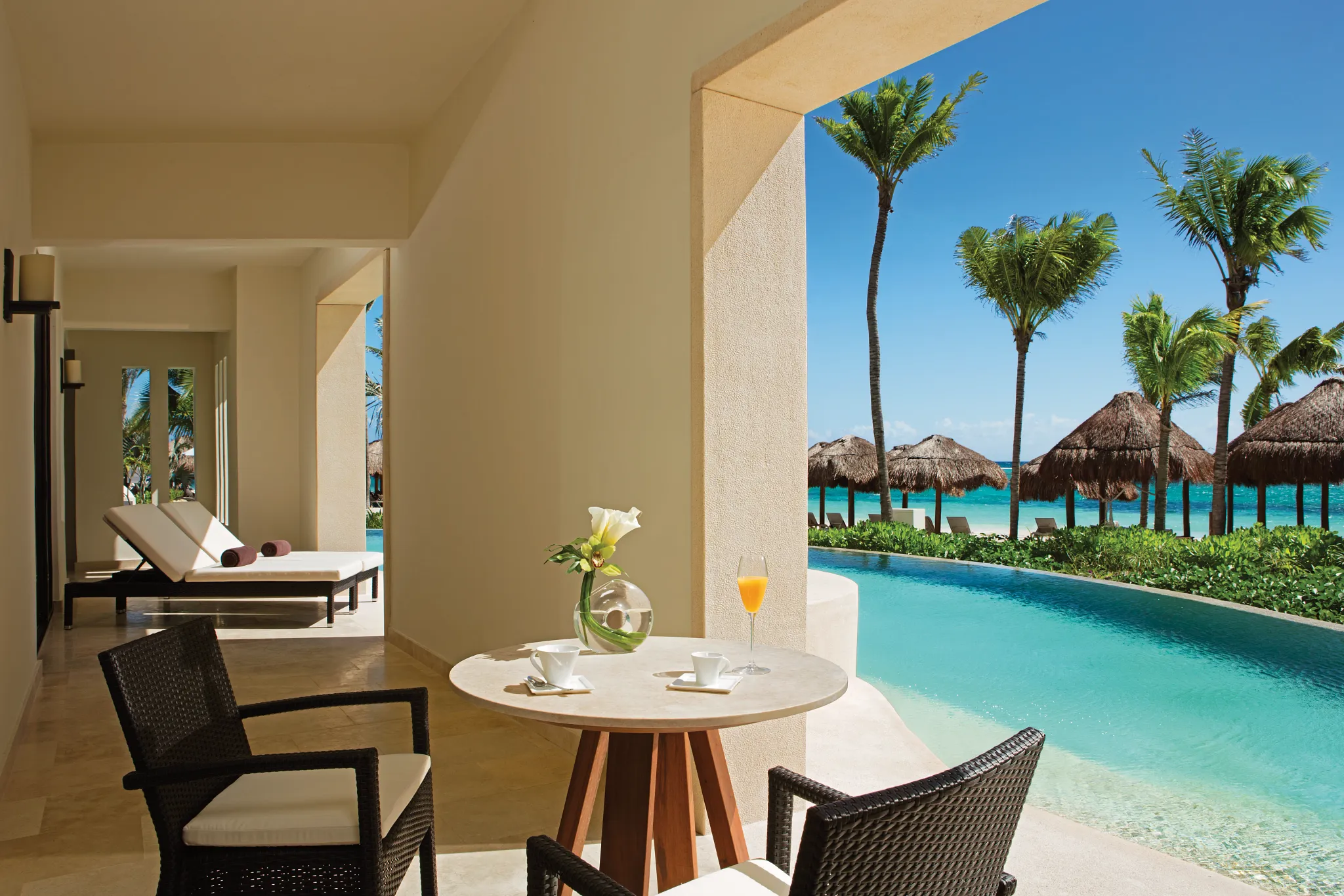 Romance Master Suite Swim Out patio with table for two and swim-out pool at Secrets Akumal Riviera Maya near the beach.