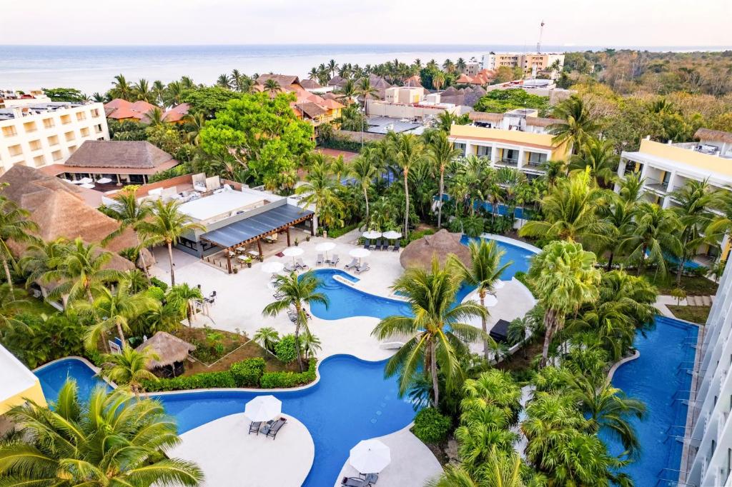 Secrets Aura Cozumel adults-only all-inclusive resort with oceanfront pools, modern suites, and Caribbean views on Cozumel Island, Mexico.