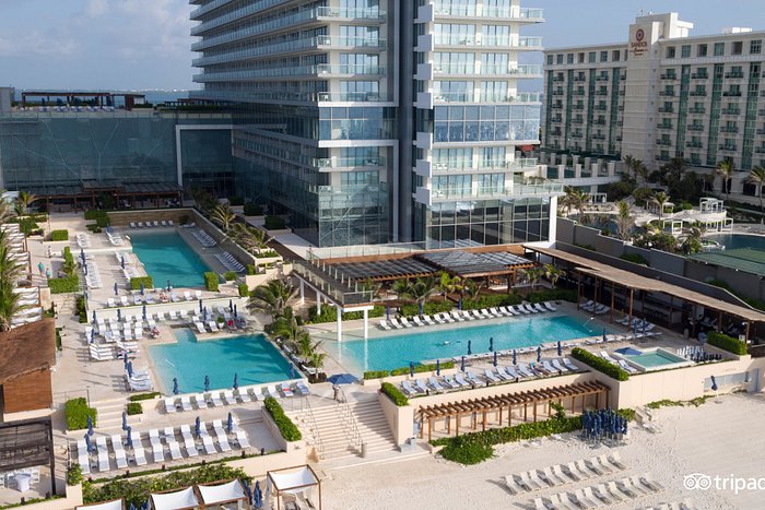 Secrets The Vine Cancun adults-only all-inclusive resort with modern high-rise tower, rooftop pool, and beachfront location in Cancun Hotel Zone.
