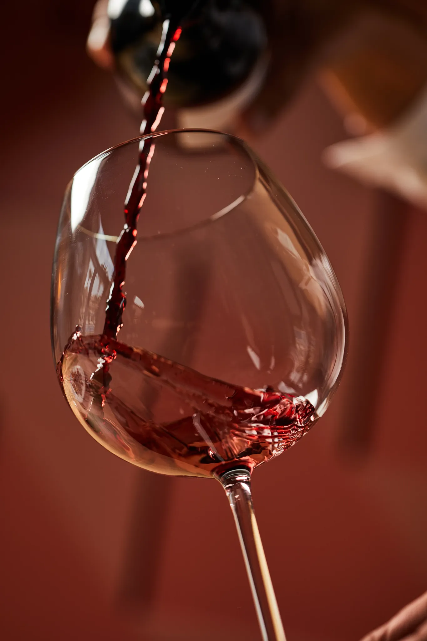 Showtime Theater Bar at Secrets Akumal Riviera Maya featuring a close-up of red wine being poured into a glass, perfect for cocktails and drinks during nightly shows.